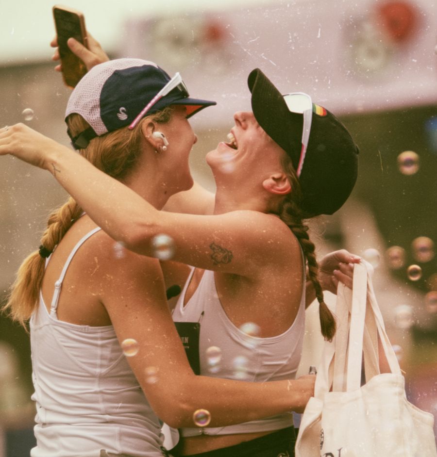 Two runners hugging